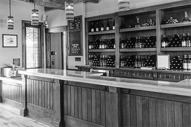 a black and white image of a wine bar