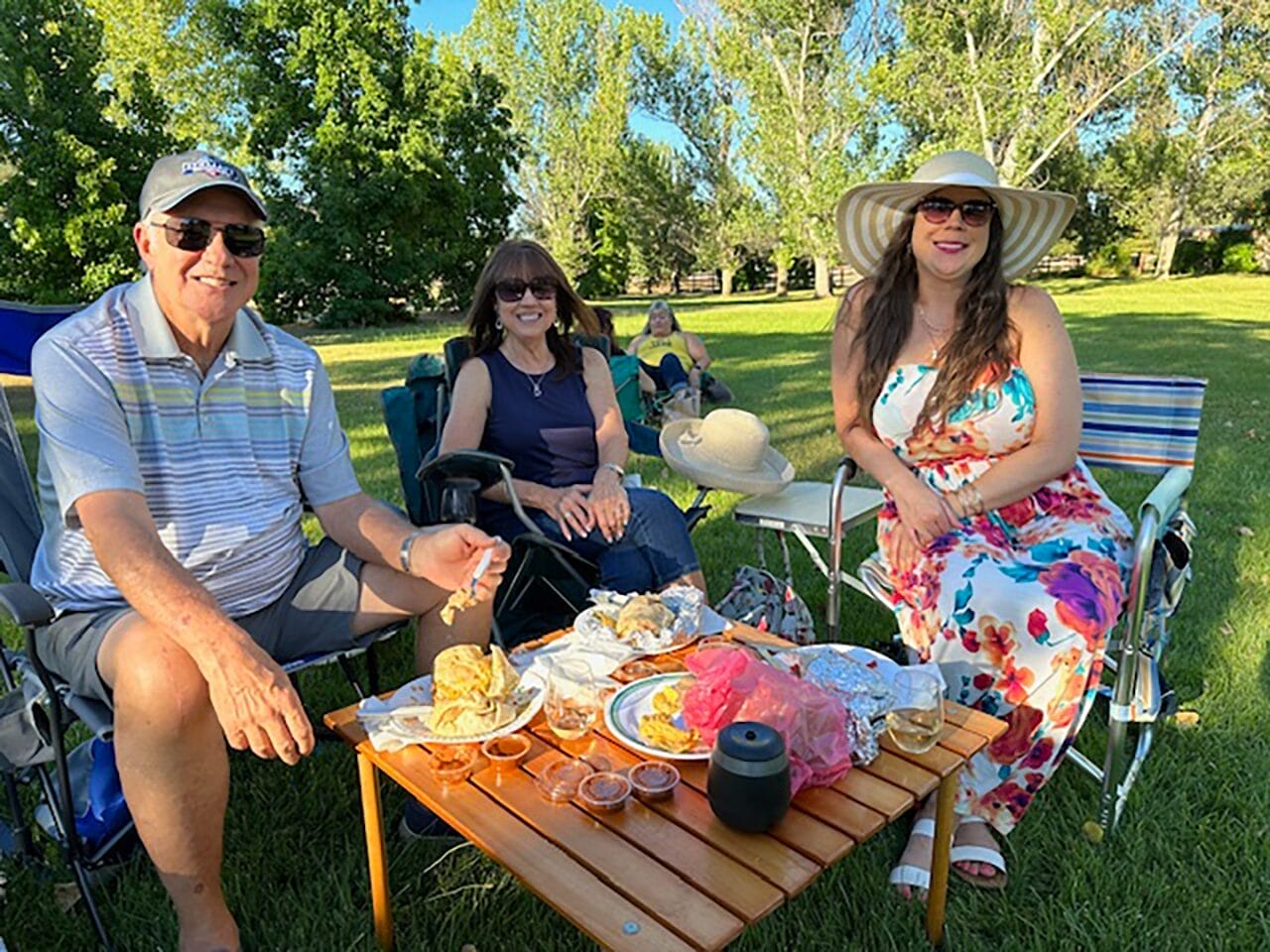 three people winding down at a park event