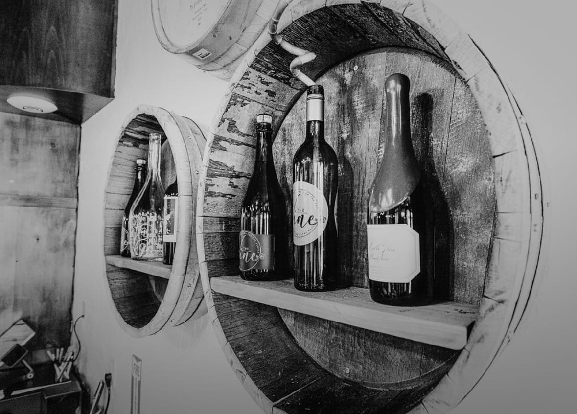 Black and white, wine bottles against the wall